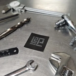LOP sticker on work bench surrounded by tools