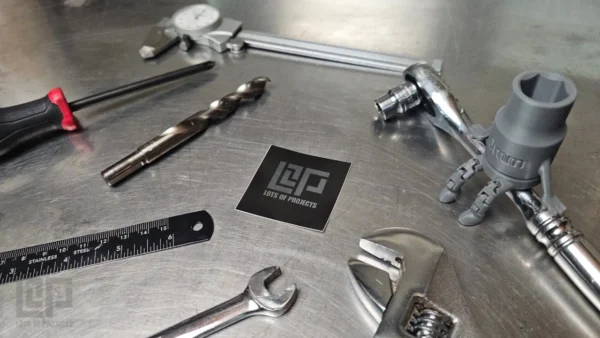 LOP sticker on work bench surrounded by tools